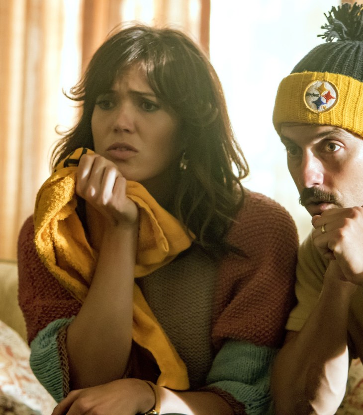 Jack and Rebecca Pearson sit on the edge of their seats watching the football