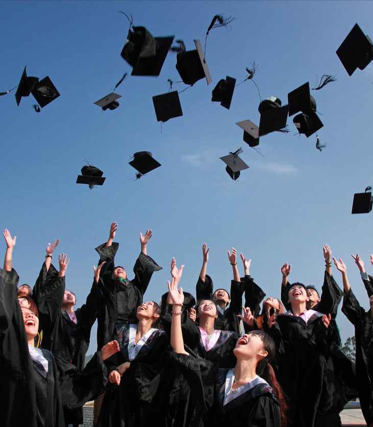 Students throw their caps in the air at graduation