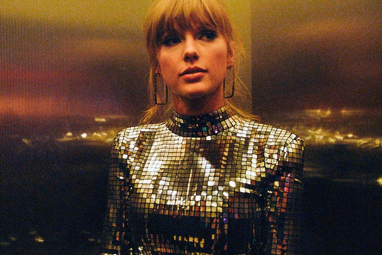 A still from 'Miss Americana'. Taylor Swift stands in a lift with a glittery outfit on.