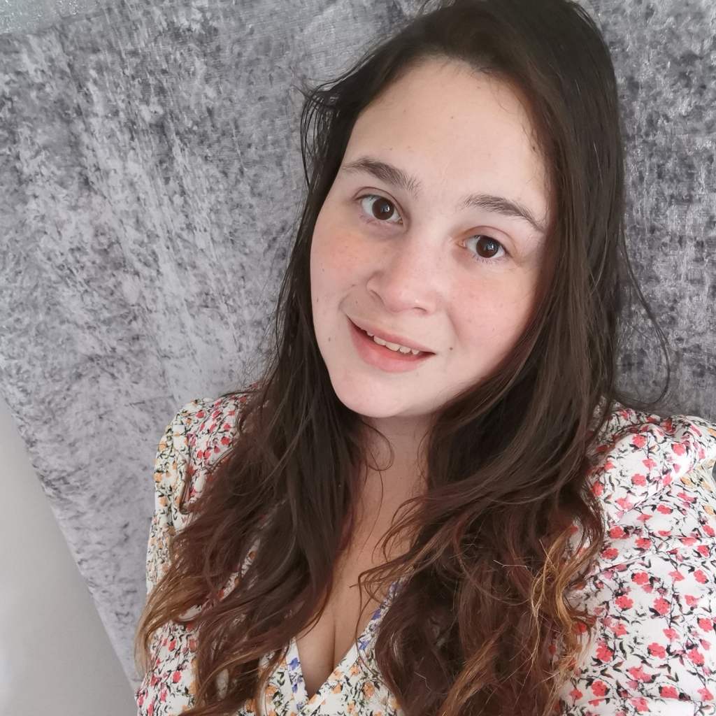 Woman stands by a tree