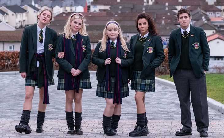 Image from Derry Girls series, school children stand and pose for the camera