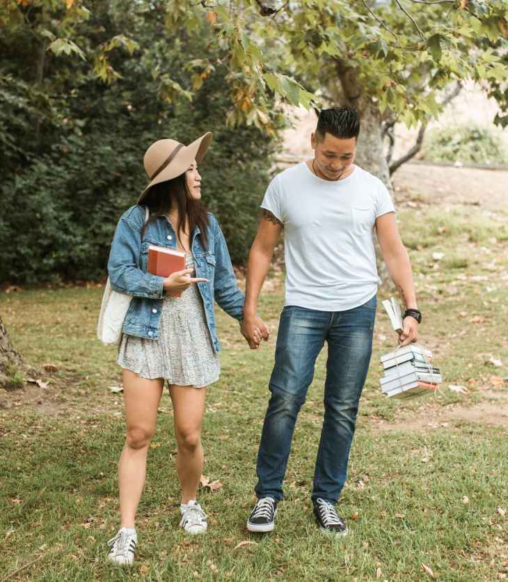 man and woman standing on green grass field