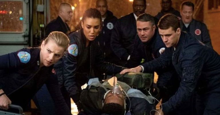A still from the series 'Chicago Fire' where the characters help an unconscious man.