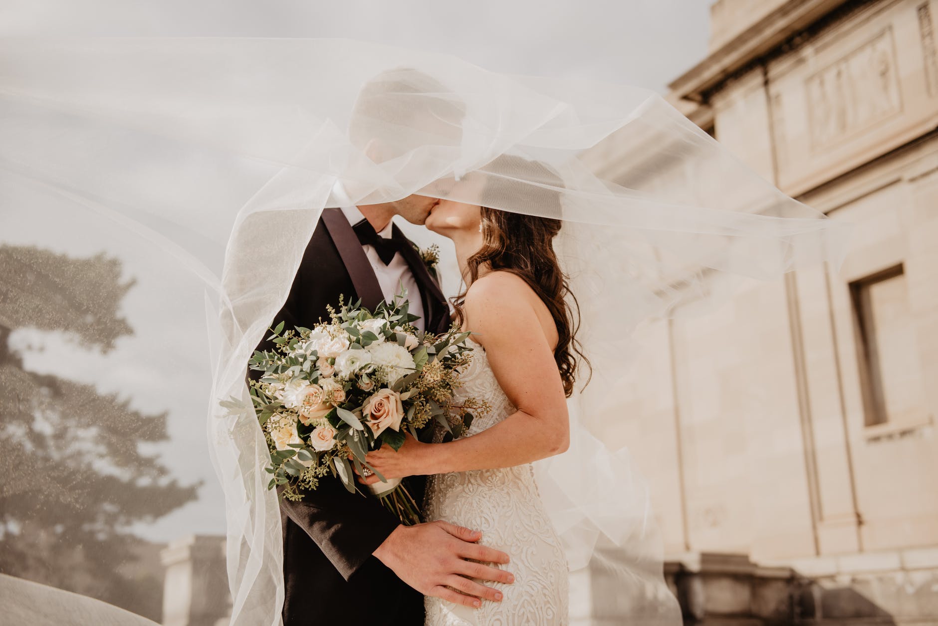 man and woman kissing at a covid wedding