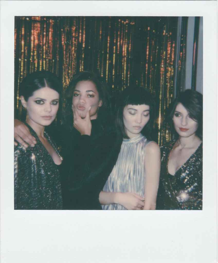 A Polaroid style photo of four young girls.
