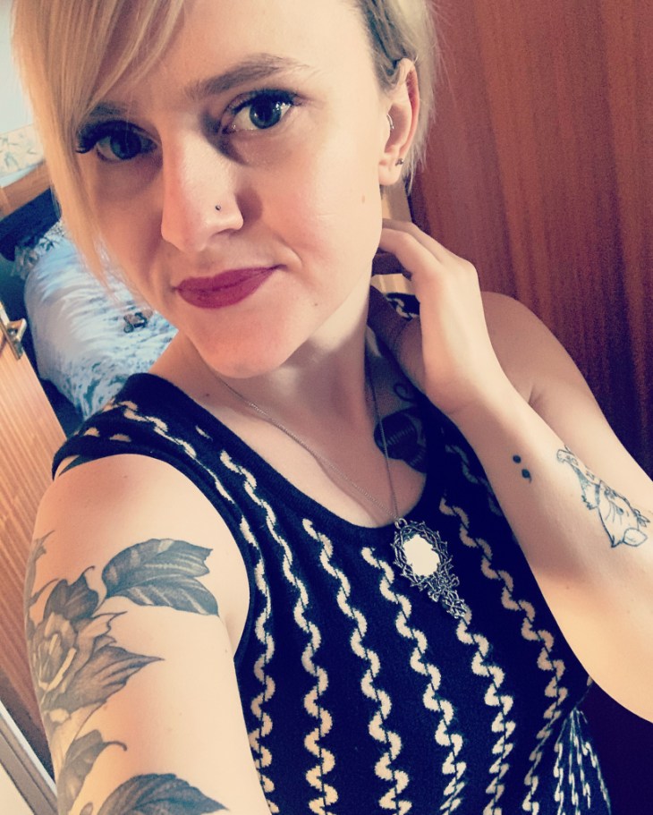 A young woman takes a selfie.