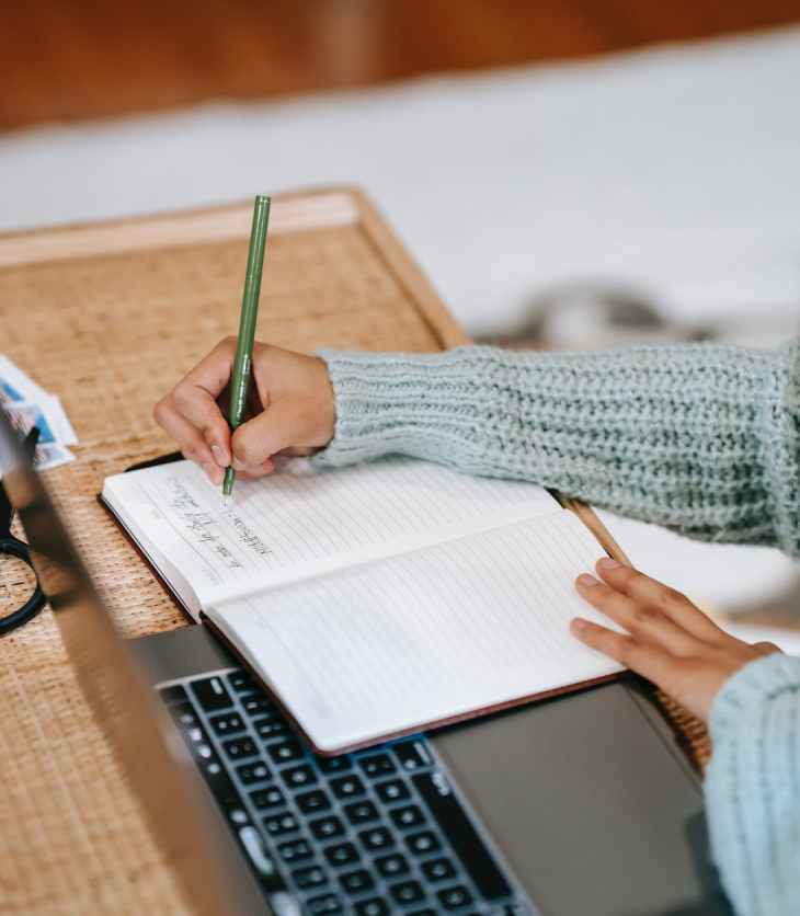 Effective blogging routine- blogger writing in a notebook