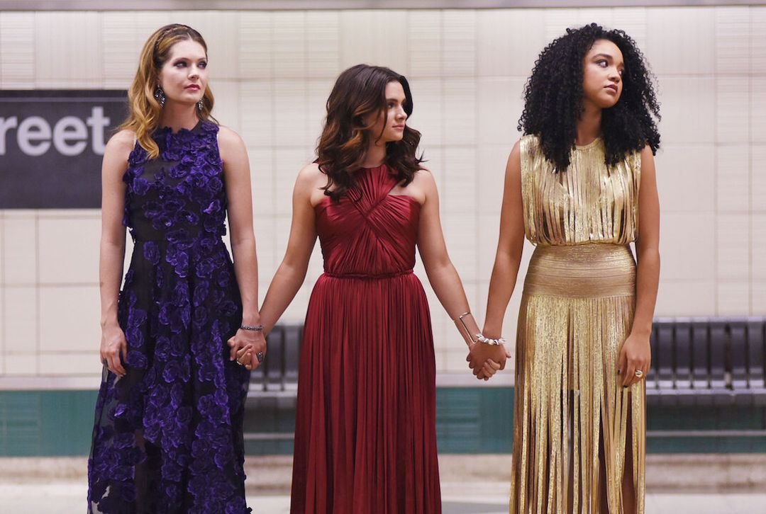 three women from the bold type holding hands in the subway