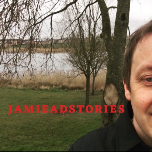 Image of a lake and trees with a man stood to the right hand side, his face half obscured. The words "Jamie Ad Stories" in the middle.