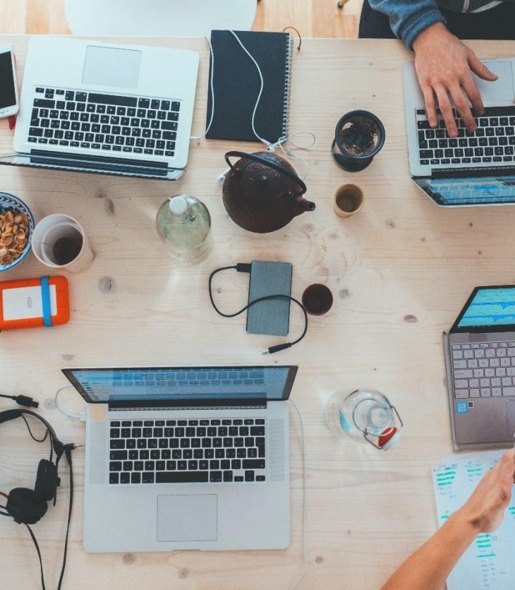 people using laptops at a table to make connections online