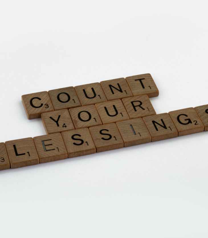 Wooden tiles spell out "Count Your Blessings" for gratitude