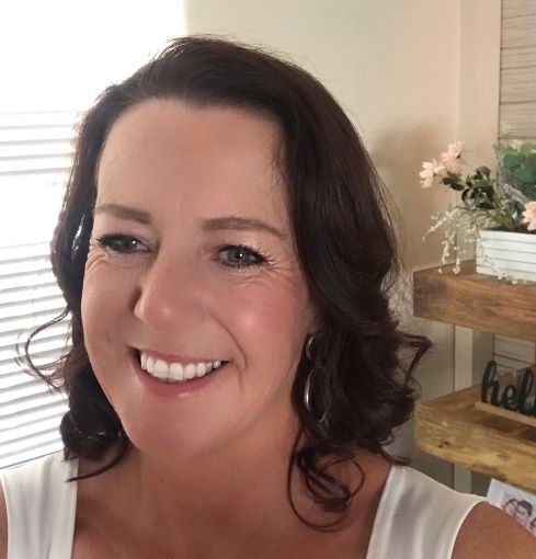 Image of a brunette woman smiling at the camera