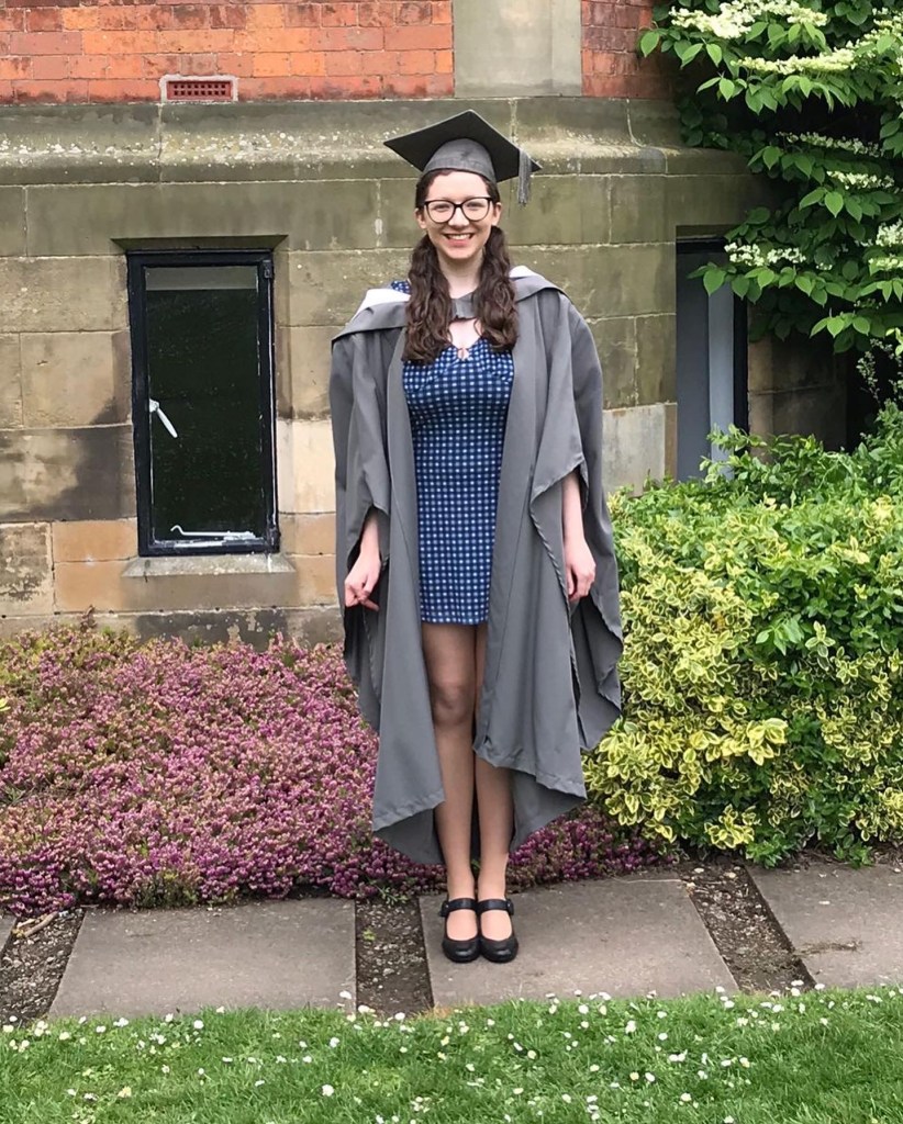 Eleanor at graduation, wearing a grey cap and gown and smiling in portrait. 8 things to do after you've finished University