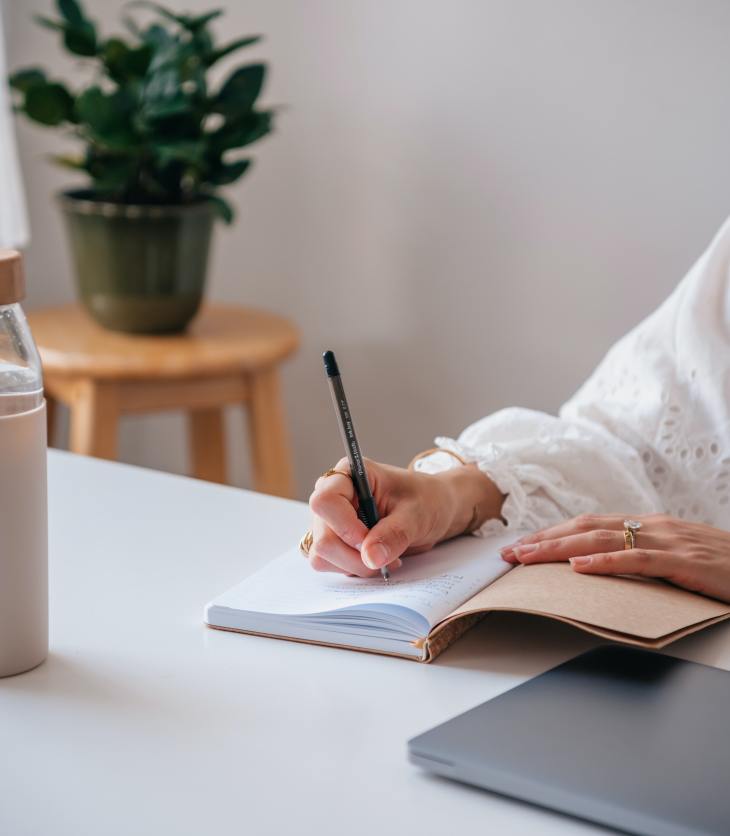 person writing in a notebook- 8 Healthy Habits for Self-Improvement to Become Your Best Self