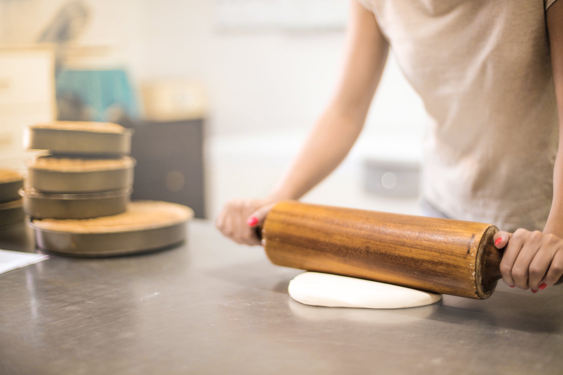 person in white t shirt rolling a pin in dough- making the most of Bake-Off