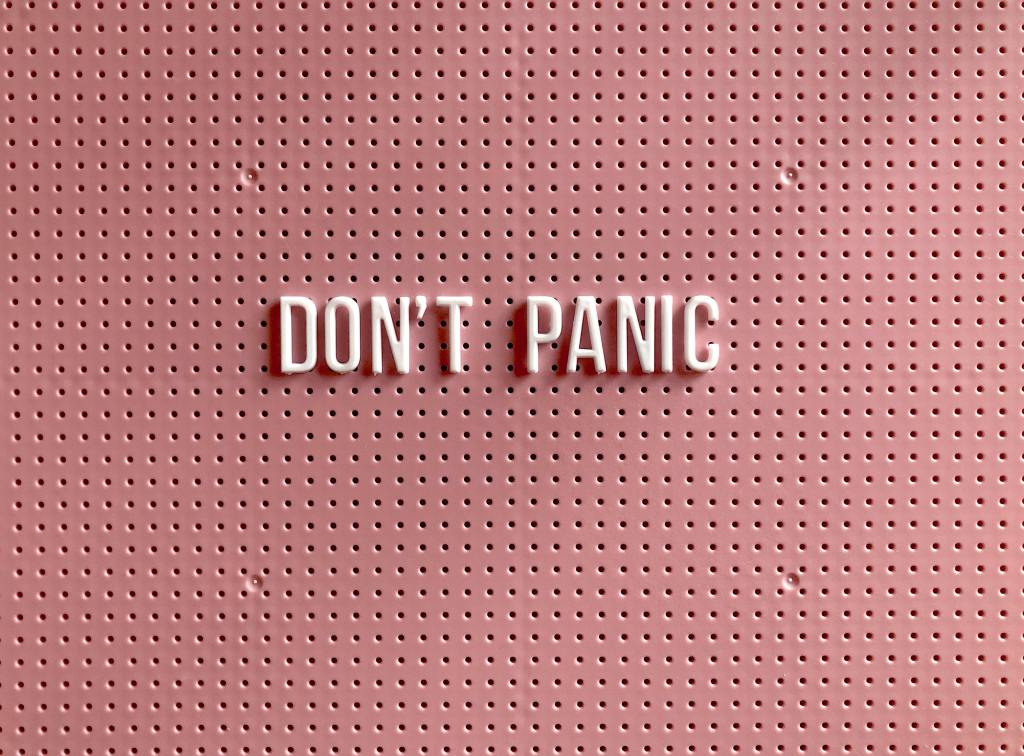sign that says "don't panic" on the wall- avoid burning out