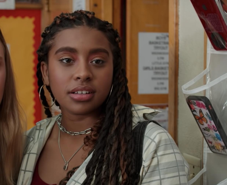 Lucy in the film Moxie, standing by her locker at school