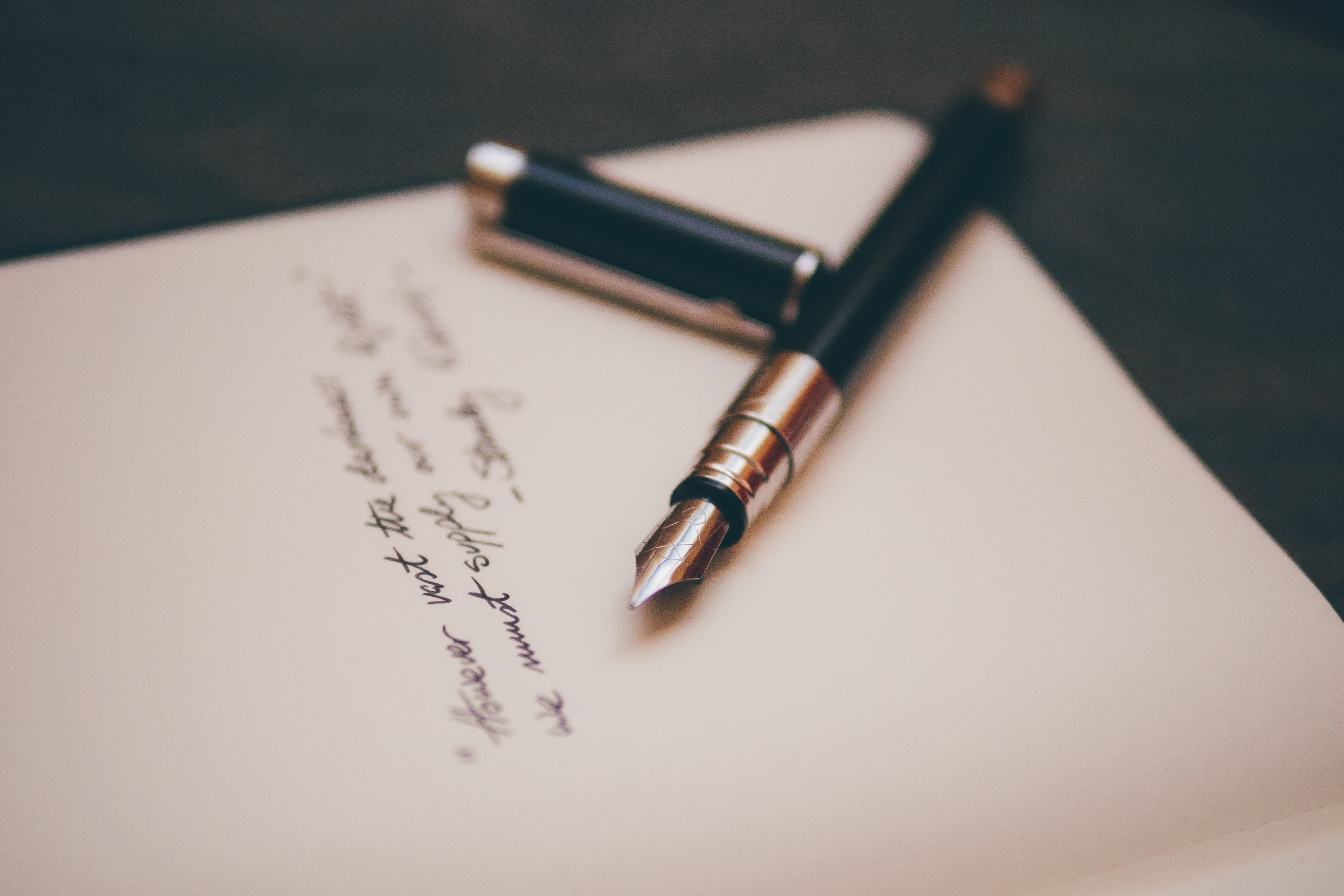 piece of paper and fountain pen- writing a handwritten card for a loved one