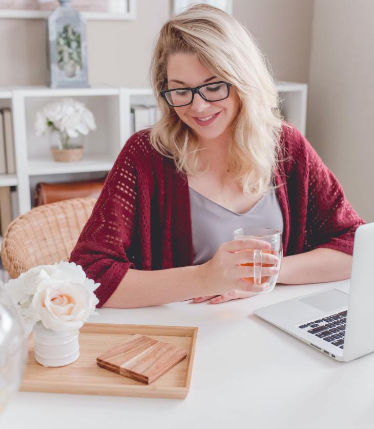person working at a laptop, smiling