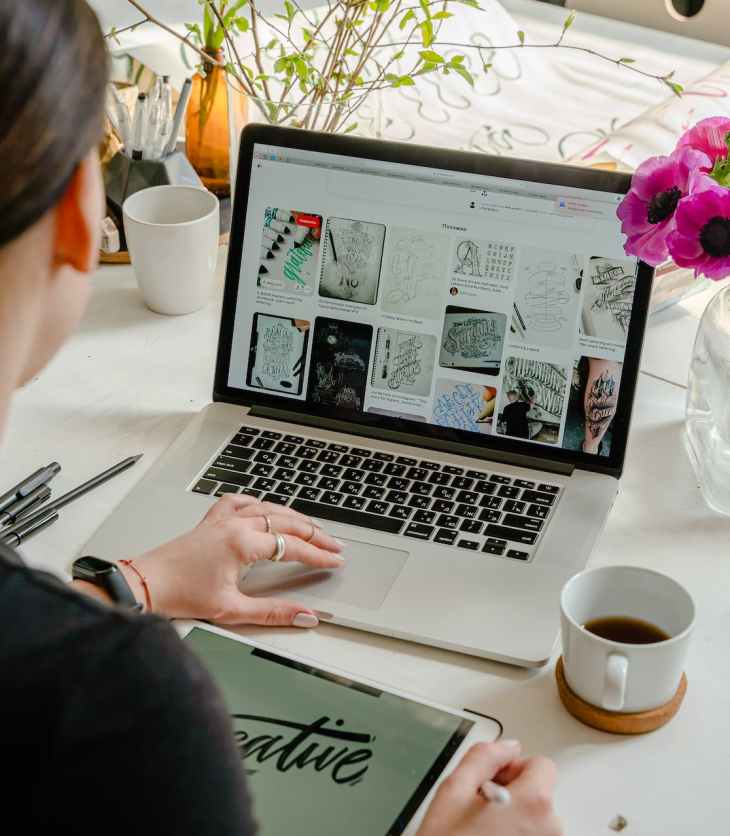 photo of person using laptop for graphic designs