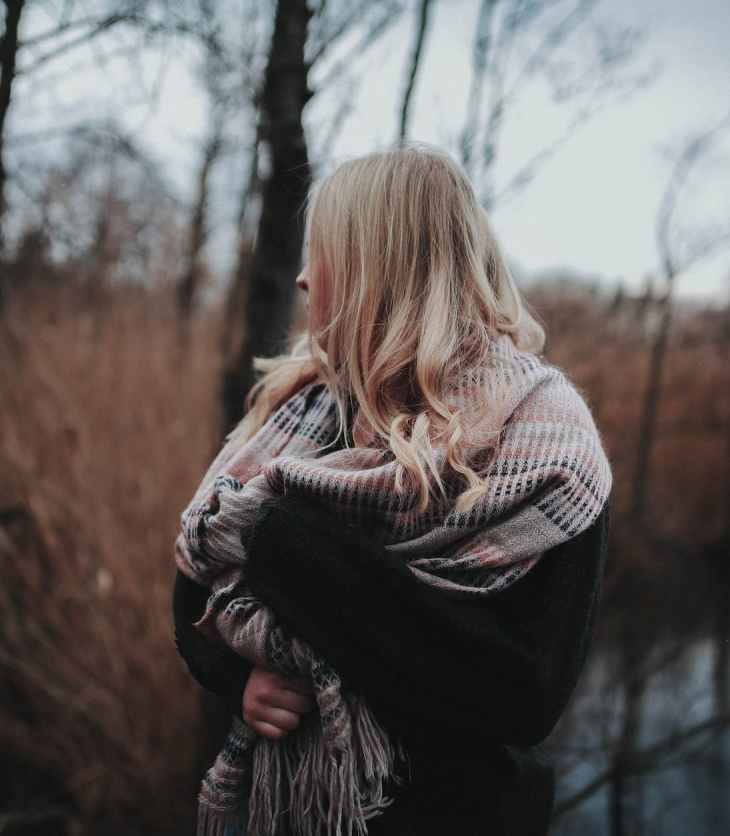 woman wearing black coat and white scarf