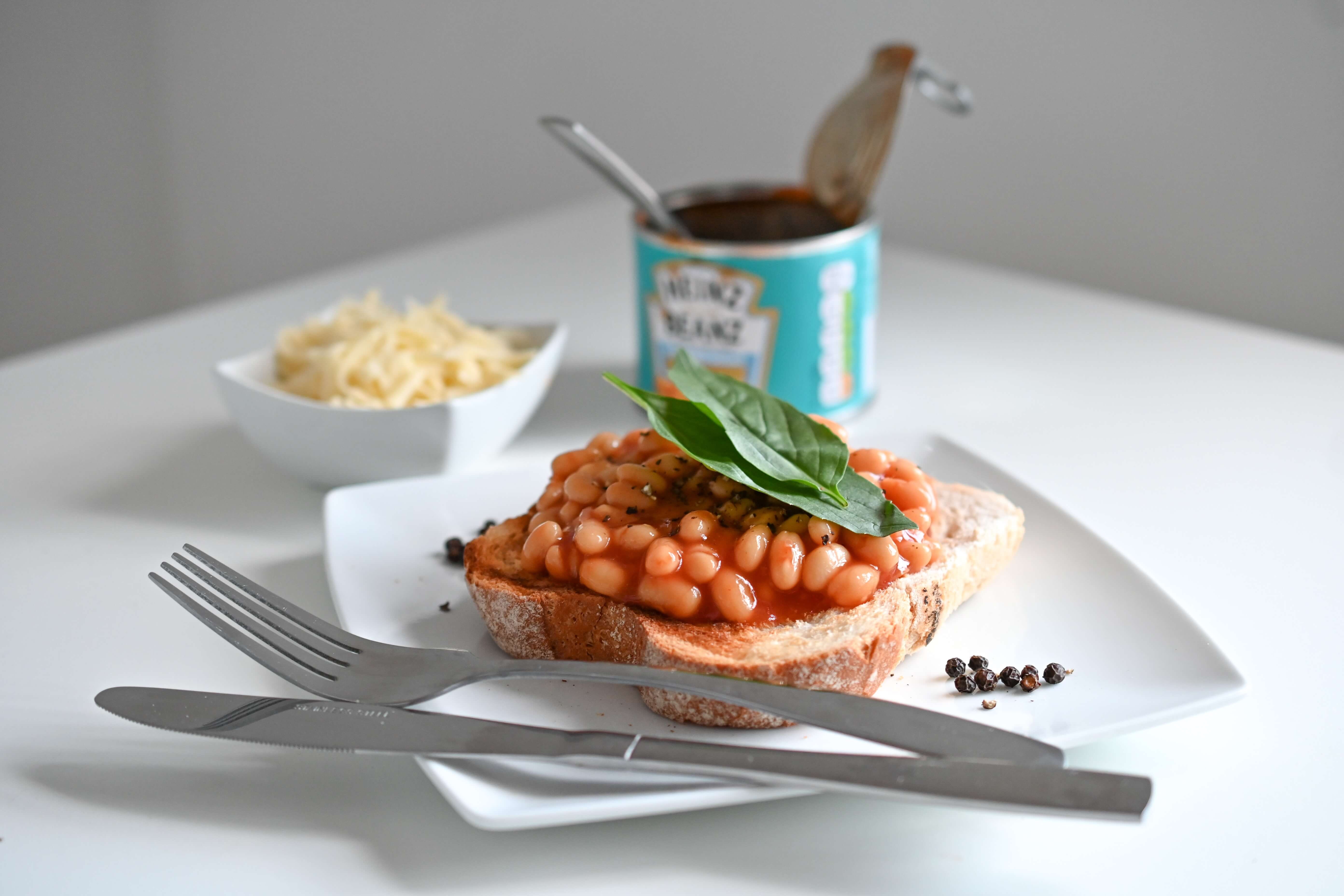 Beans on toast with Heinz beans can and grated cheese in a bowl: lunch ideas for remote workers
