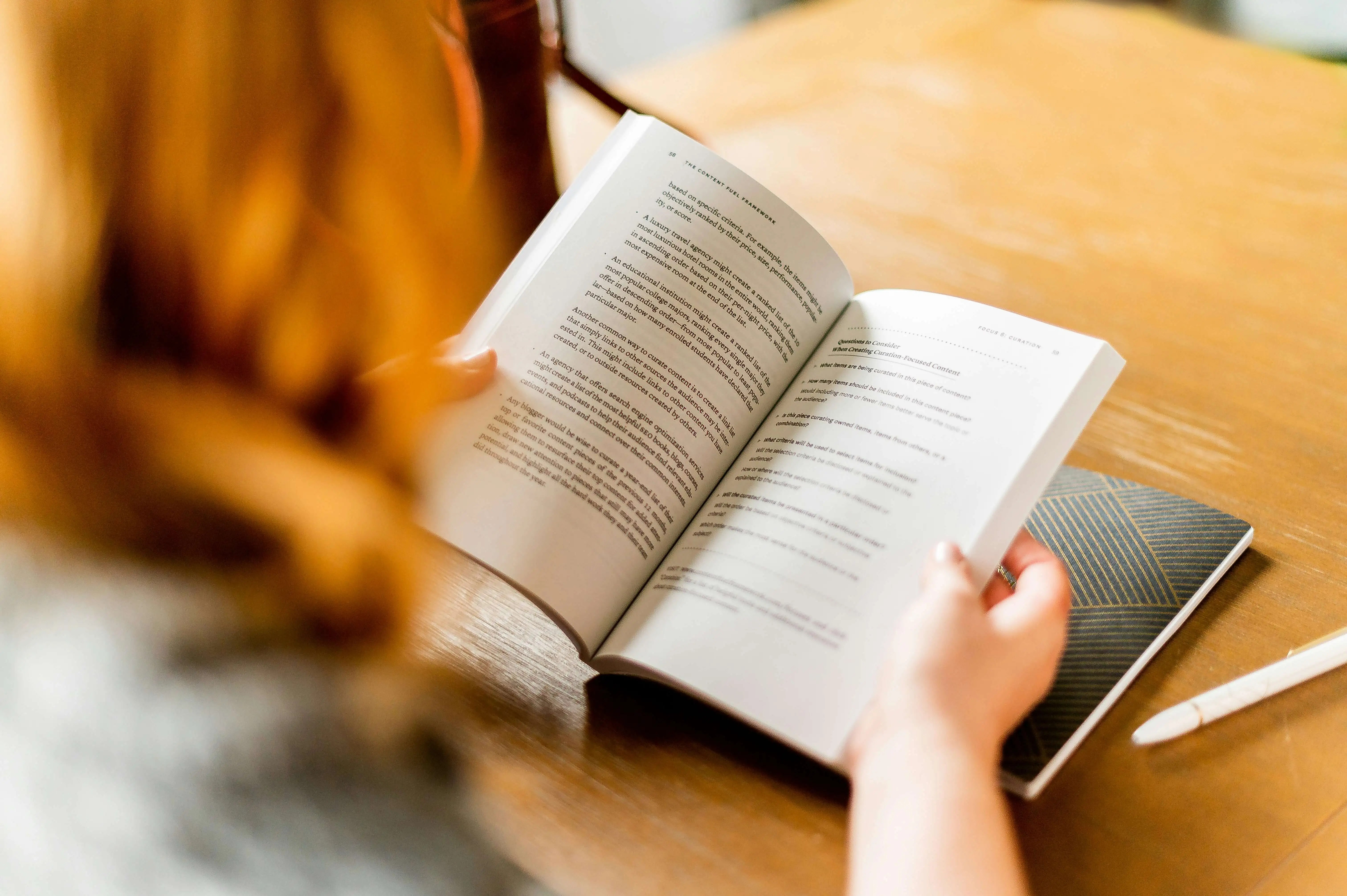 person reading a book at a desk
