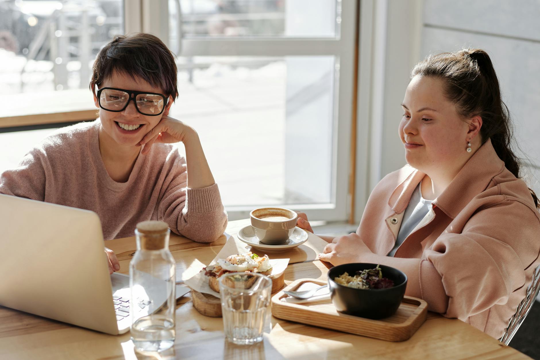 happy young people watching on a laptop