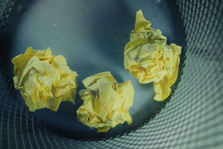 scrunched up balls of paper in an empty bin