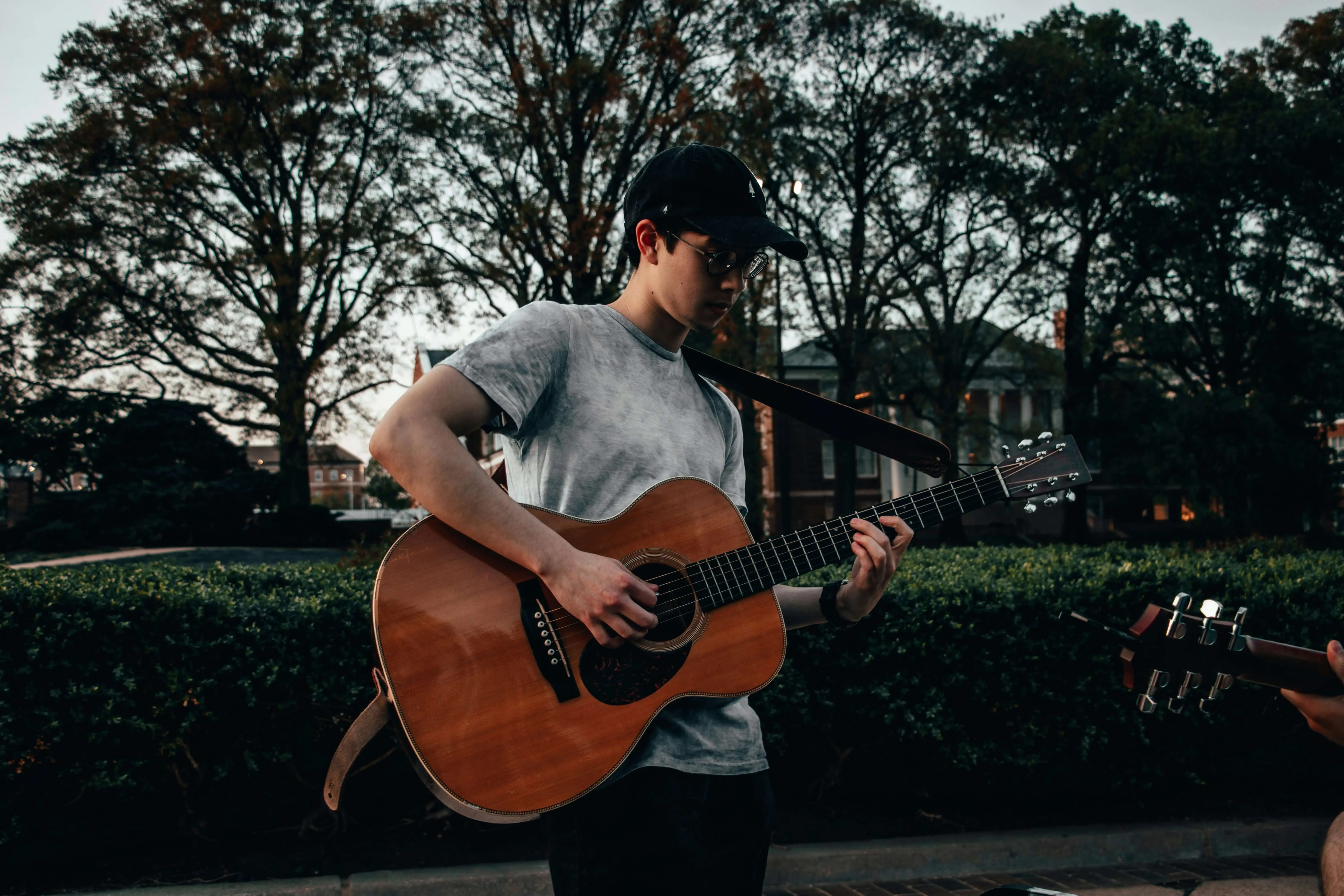 person playing a guitar outside: 17 ways to romanticise your summer