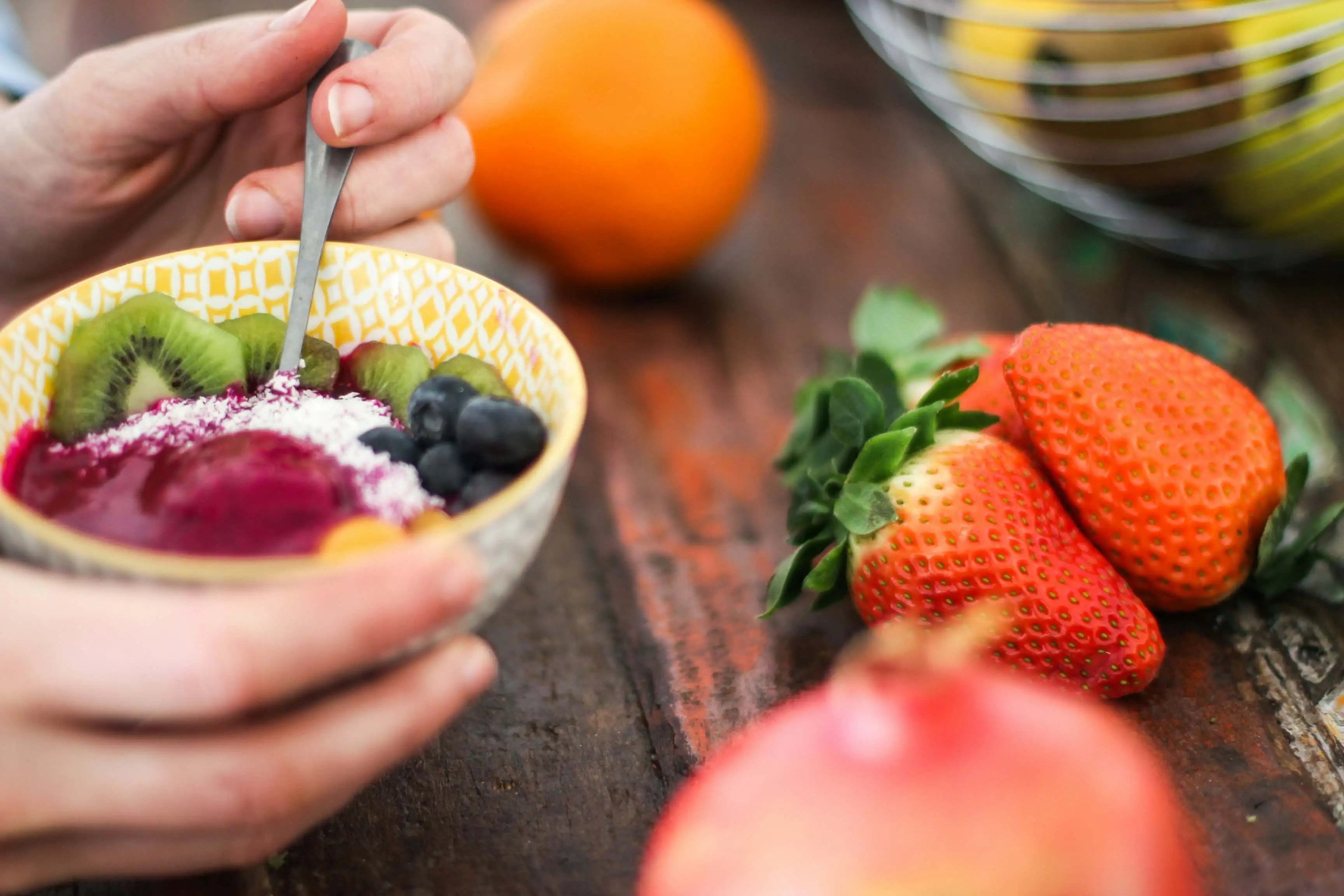 bowl of fruit with strawberries on the table: snack ideas for remote workers