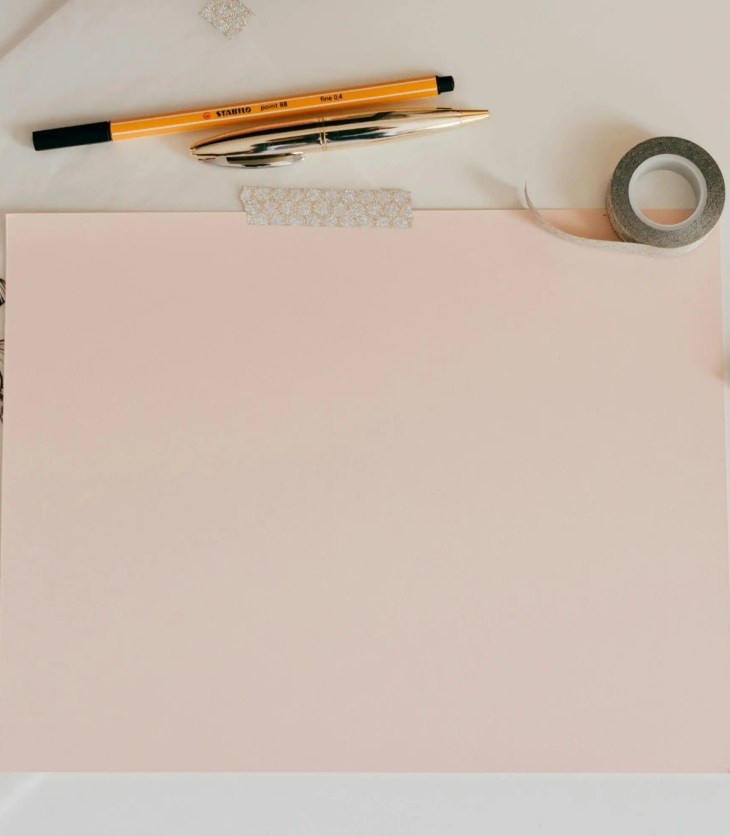 piece of paper with drawing and writing supplies: start your writing portfolio