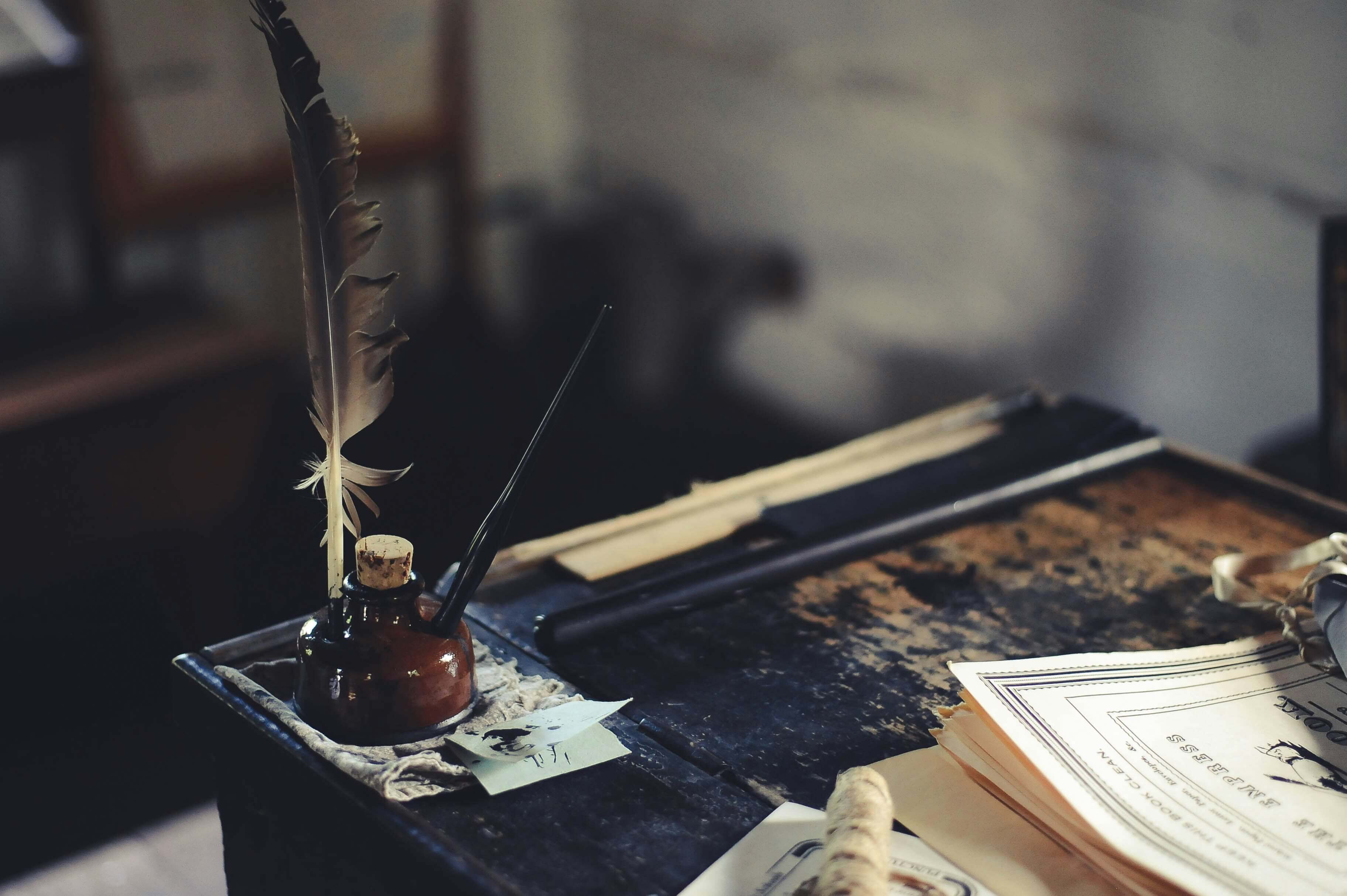 quill on an old desk with papers: daily exercises to boost your creativity