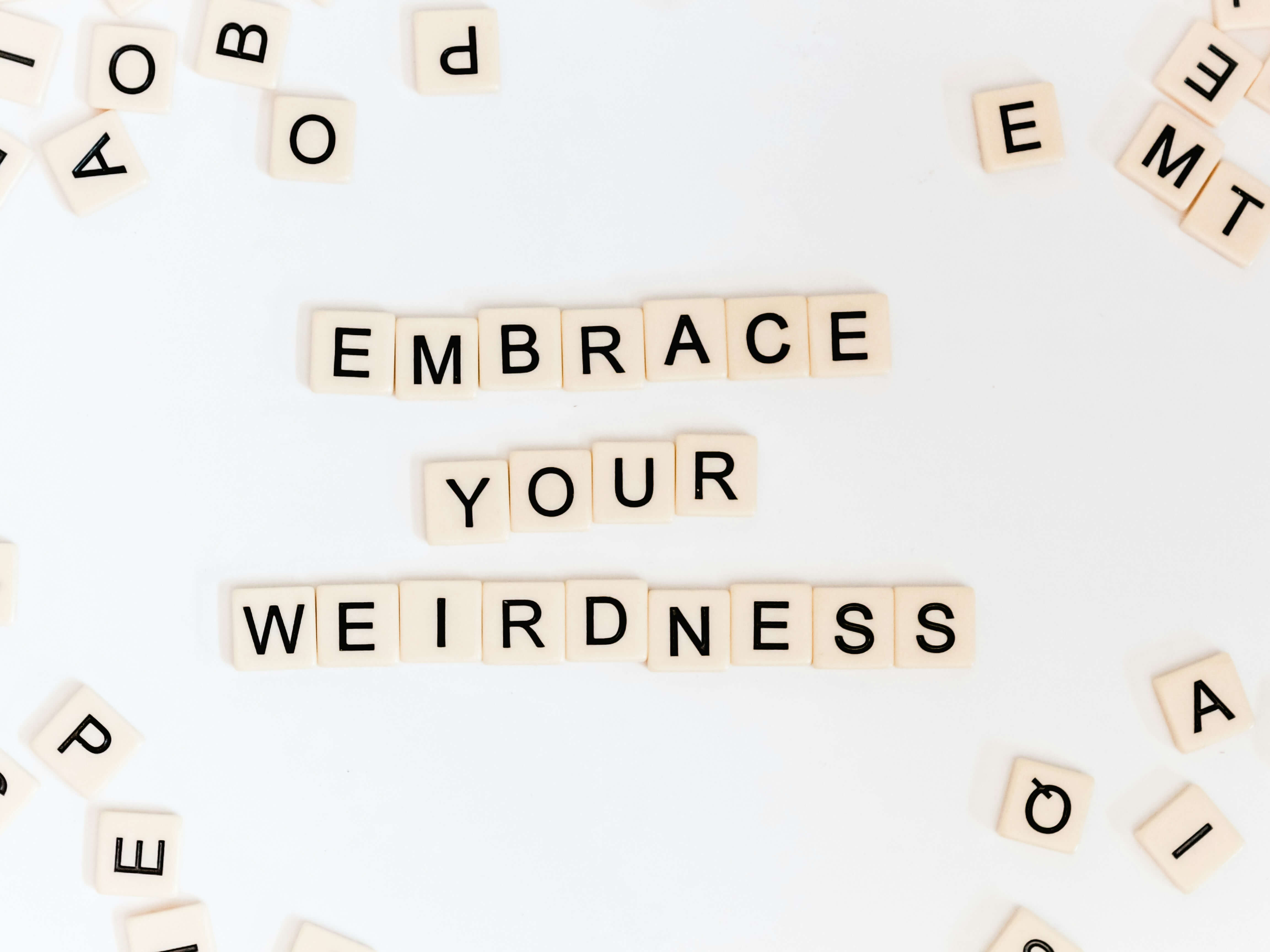 scrabble tiles that say "embrace your weirdness": easy writing prompts