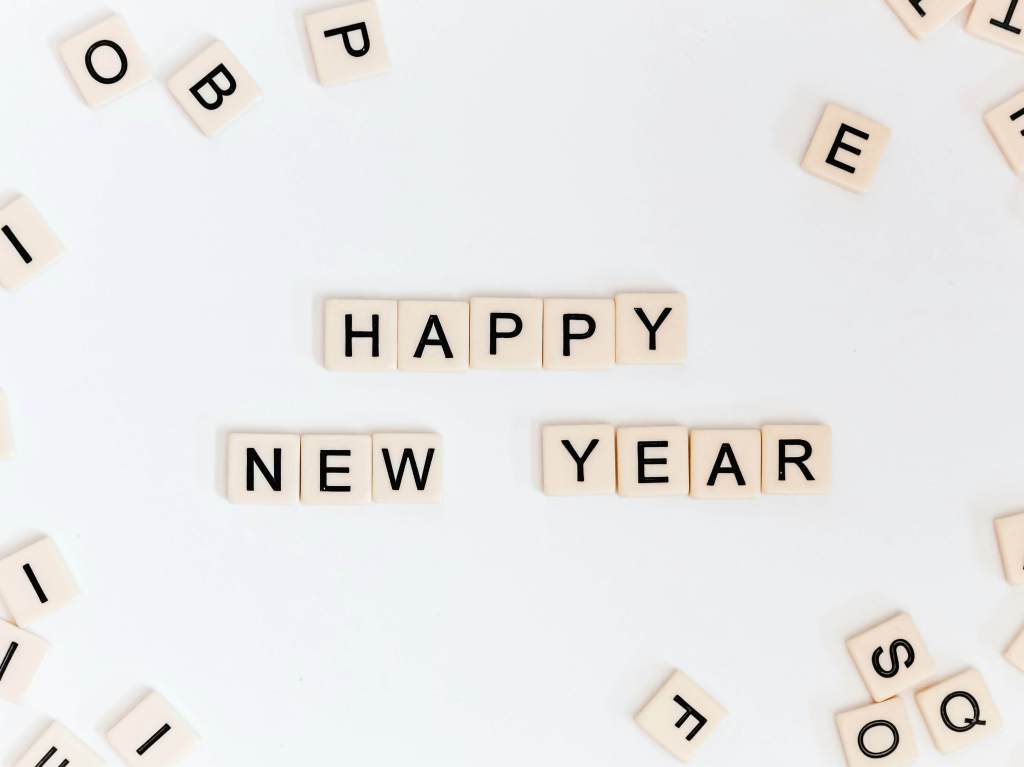 happy new year spelled out in scrabble tiles