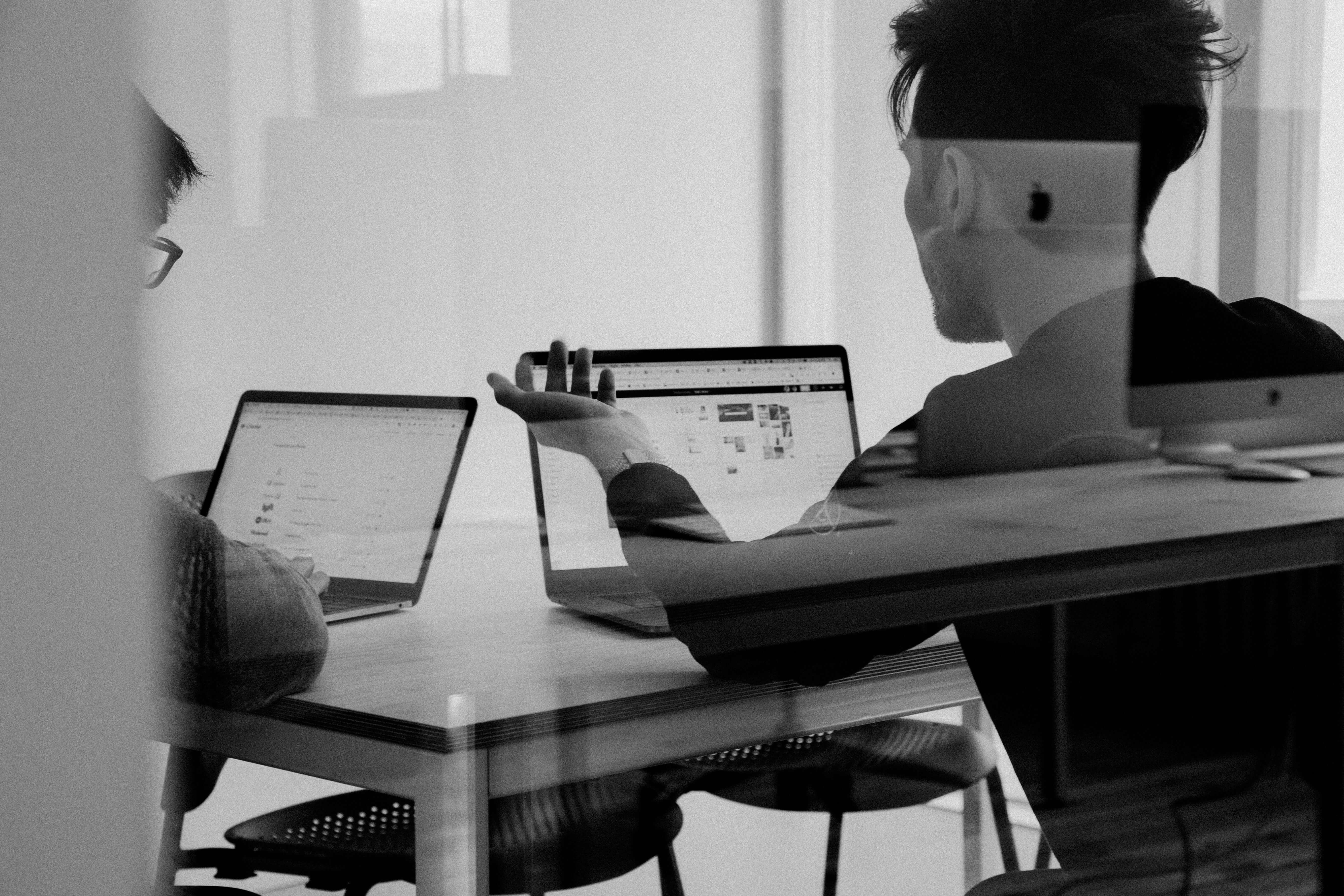 black and white image of people chatting and consulting
