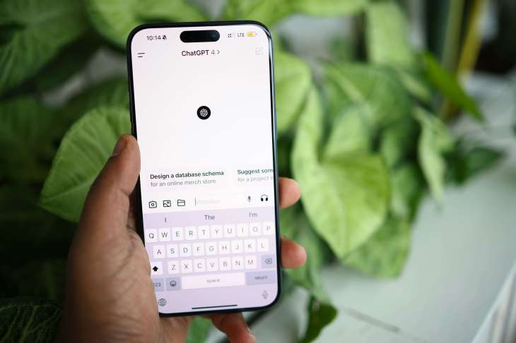 ChatGPT open on a mobile phone with a plant in the background